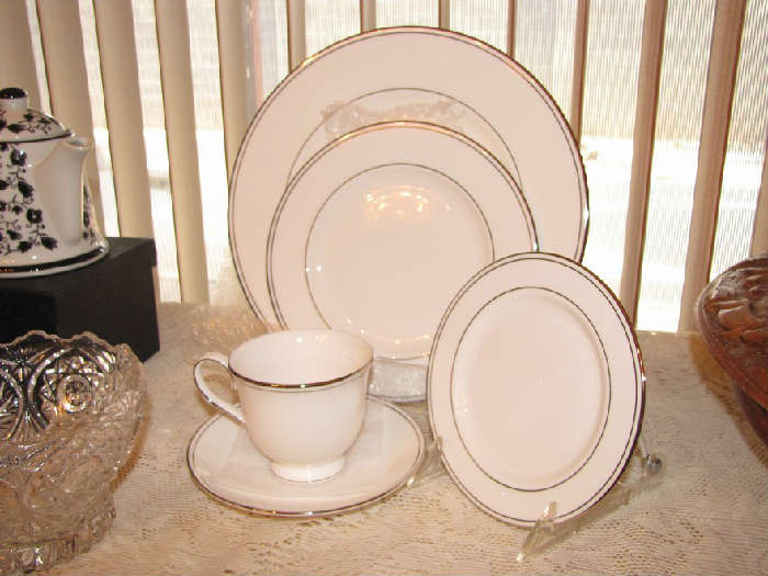 This Lenox Platinium 5 pc place setting IS NEW IN BOX for $25.00.  We have 8 available on 8/15 at the sale.
