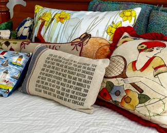 Decorative painted, needlepoint, and vintage throw pillows.