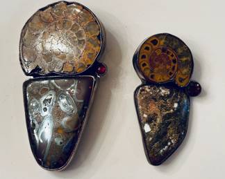 Vintage sterling mounted ammonite fossil brooches designed by Amy Kahn Russell