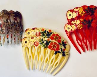 Artisan designed hair combs, including hand-painted in center and on right