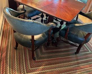 Vintage game table with four green leather chairs