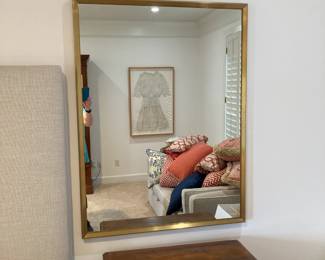 One of two large gold framed mirrors