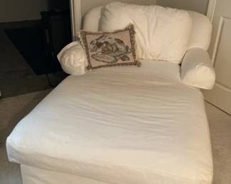 White upholstered chaise with rolled arms, loose pillow back