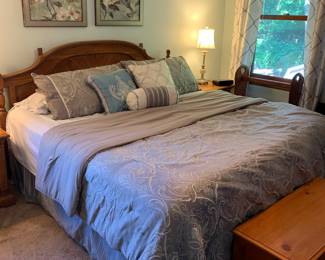 King size bed, oak headboard, nice bedding, nice art
