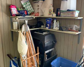 a corner of the garage, grill