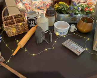 Close up of rustic crockery, step ladder, irons and other vintage items