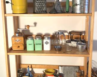 Vintage kitchen items: German coffee grinder, jadite S & P set, sifters, syrup pitcher & more