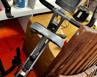 exercise machine and comfy wooden chair... nice combo.. work out, and relax!