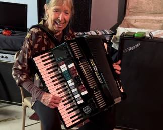 Aunt Sandy demonstrates the accordion 