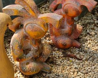 Two Kokopeli style terra cotta figures for the garden or patio....or create a rustic interior vignette.