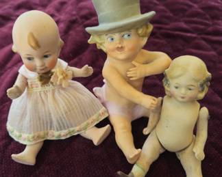 Small vintage porcelain dolls and boy in top hat figure.