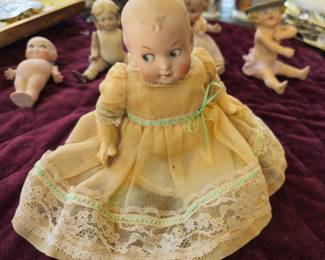 Googly eye doll in original dress, shoes and socks, under garments. No bonnet.