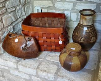 Large leather cow bell, leather basket, and pottery vases.