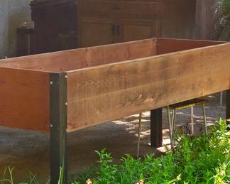 raised wood bed, never used. Approx 6' long or more.