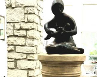 Beautiful sculpture of mother and child and a tall and sturdy pedestal. Priced separately.
