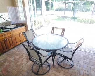 Patio set and lots of outdoor glasses/pitchers/serving trays. 