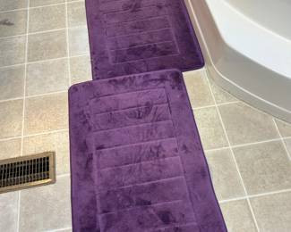 Two large purple bath mats