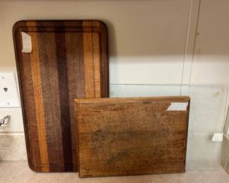 Two wooden and one acrylic cutting boards
