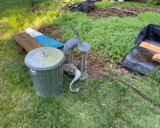 Yard art and metal trash can