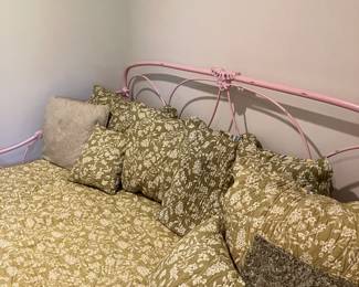 Pottery barn  wrought iron day bed with green bed covering 