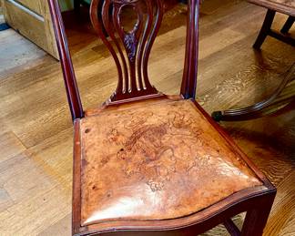 LOVE THESE TOOLED LEATHER LION FACE DINING CHAIRS.