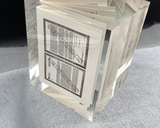 Tiny insurance policy inside a glass cube