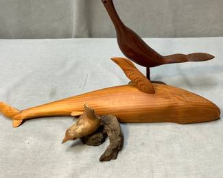 Carved wooden whale and birds