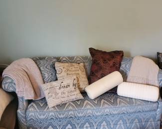 Couch, throw pillows, blankets