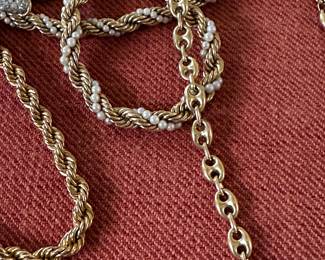 Lots of gold chains and bracelets