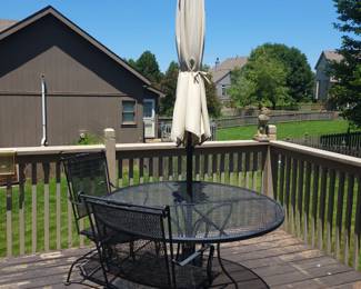 WROUGHT IRON TABLE AND TWO SPRING ACTION CHAIRS $125/ UMBRELLA AND BASE $50