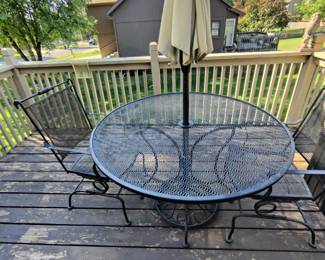 WROUGHT IRON TABLE AND TWO SPRING ACTION CHAIRS $125/ UMBRELLA AND BASE $50