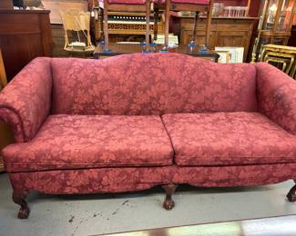 Wonderful Camel Back 2 Cushion Sofa with Rolled arms and carved feet.