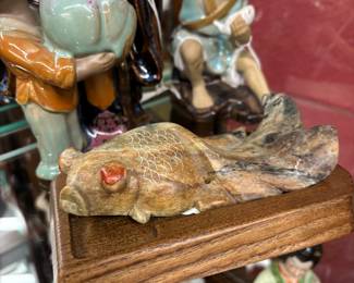 Look at this stoneware fish sculpture on platform