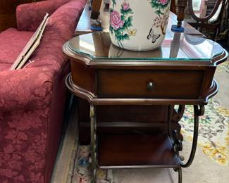 Nice wood and iron end table with glass cut to shape of table.