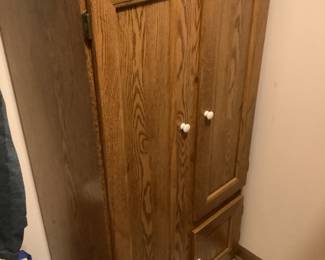 Oak cabinet.  Measures 53” h x 28” w x 16” d.  Has shelving plus hanging space.  $60