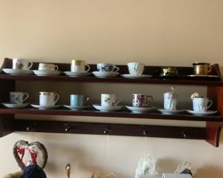 Wood shelving with another collection of cups and saucers