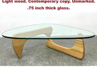 Lot 642 ISAMU NOGUCHI style coffee table. Light wood. Contemporary . Unmarked. .75 inch thick glass.