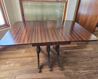 Table with 6 chairs. Sides fold down.  More leafs can be added to make it larger.  