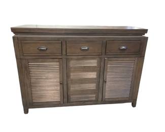 $360 USD     Shutter Sideboard Cabinet Locking Evolution Bar EK221-74 
     A locking bar cabinet allows you to store your favorite alcoholic beverages securely. If you have young children, teenagers, or expensive alcohol bottles, protecting them against damage or theft is crucial. A liquor cabinet that locks can also be an attractive statement piece in your home office or dining room. Discover our picks for the five most stylish locking bar cabinets for your home.

Dimensions:  64 x 27 x 43"H

Condition: Very good condition.  There is one spot on surface.  See photos

Local pick up Merrifield, VA.  Contact us for shipper suggestions.     
    https://goodbyhello.com/products/copy-of-bassett-sofa-sectional-ek221-73?_pos=19&_sid=873c00f68&_ss=r