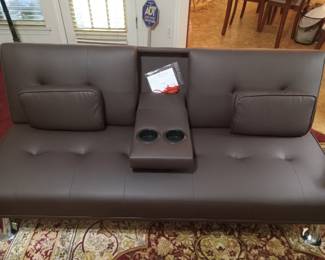 Brand New out of the box. We put it together Modern lovseat that reclines to a futon with cupholders