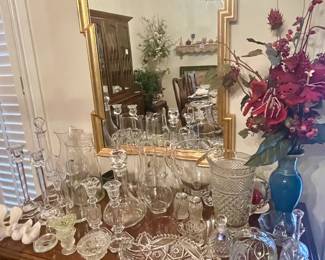 Various cut glass pieces both serving, candlesticks or display, framed mirror, floral.