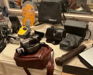 Assorted assortment of cameras, tripod, video cameras and more