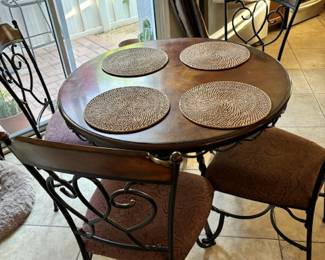Small round dining table with padded chairs 