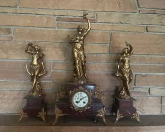 French gilt spelter clock with adornments signed Francois Moreau. Center is "Musique".  Left is "La Nuit". Right is "Le Jour".  Comes with key. Clock is working and chiming.