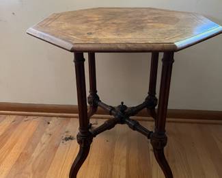 Antique Victorian octagonal occasional table w/four pillared legs on casters