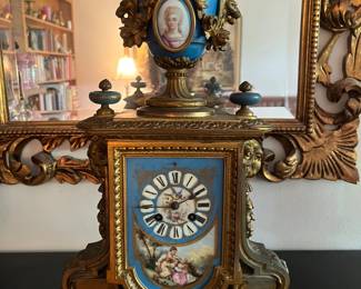 French gilt spelter clock with hand painted enamel face and medallion.  Comes with key and is ticking.  Glass missing on front and second medallion missing off the back