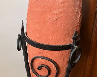 Terracotta wine jar in wrought iron stand