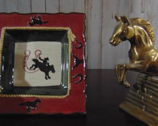 ash tray and a jumping horse statue