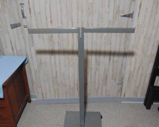 Commercial clothes rack . It adjust higher and the 2 arms pull out  to make it longer