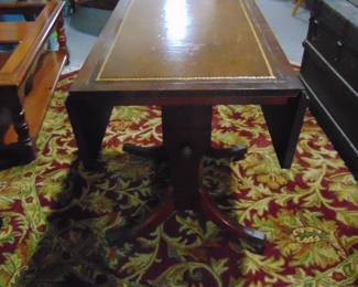 Very rare . This table with leather top and also drop leaf can be a coffee table or card or eating table . It has legs that can spring up or down